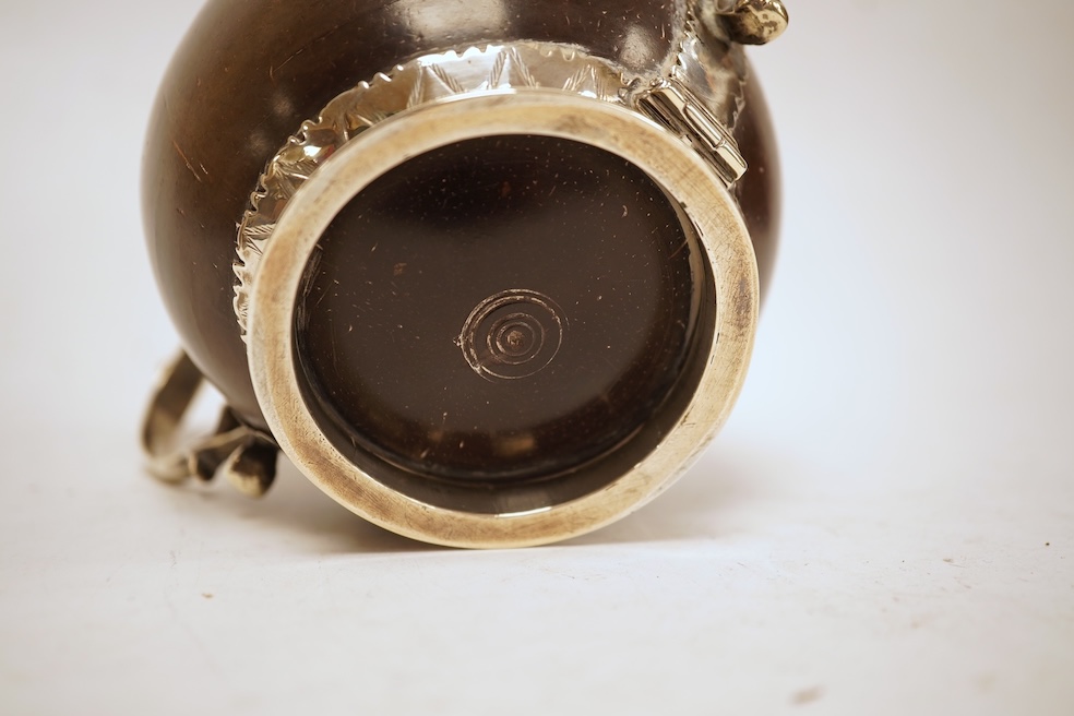 A late 19th/early 20th century white metal mounted two handled coconut cup, with engraved mounts and initials 'A IL', height 10cm (unmarked).